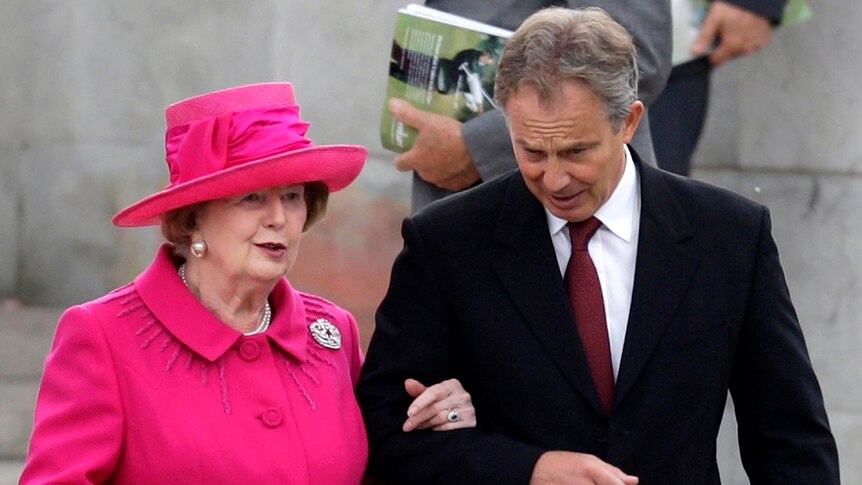 Tony Blair helps Margaret Thatcher.