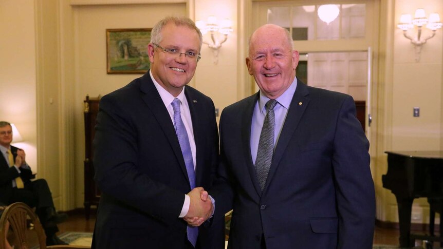Scott Morrison shakes hands with Peter Cosgrove, both smiling at the camera