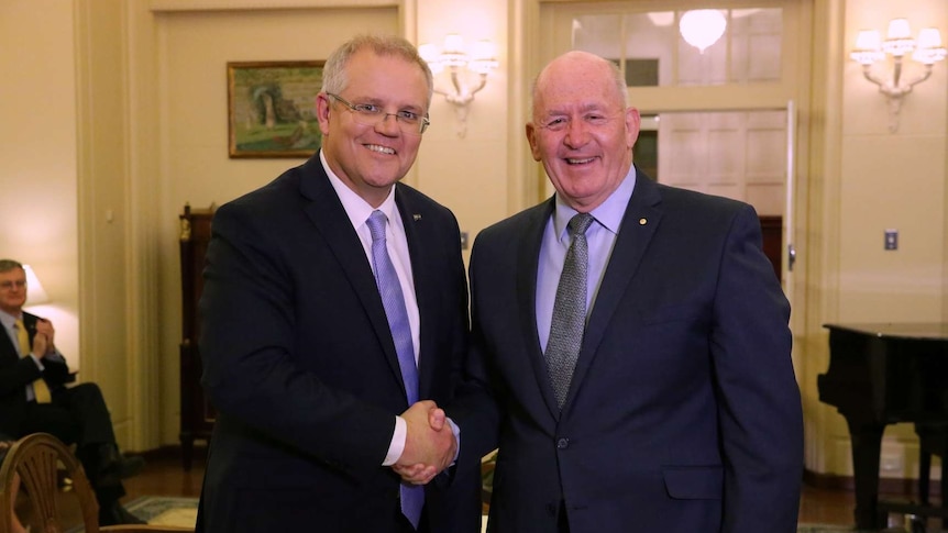 Scott Morrison shakes hands with Peter Cosgrove, both smiling at the camera