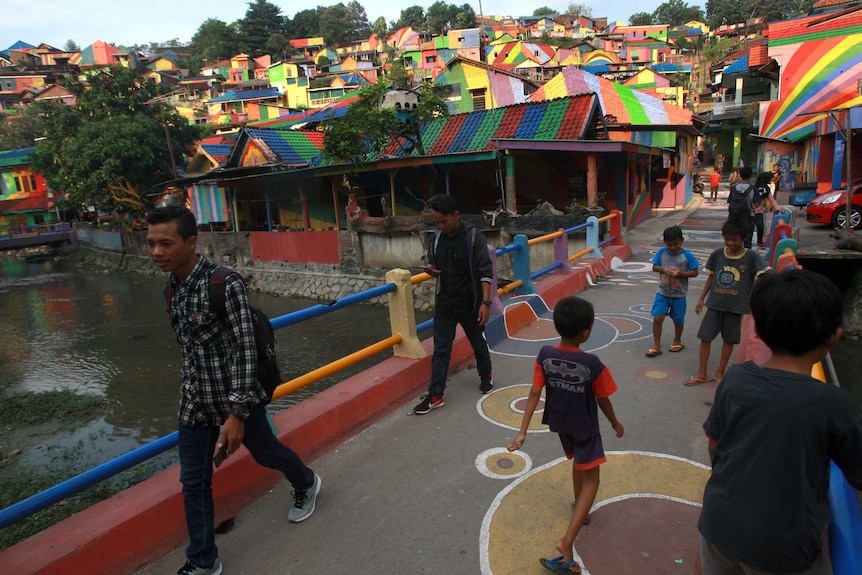 Houses and a bridge painted rainbow in Wonosari Village, Indonesia