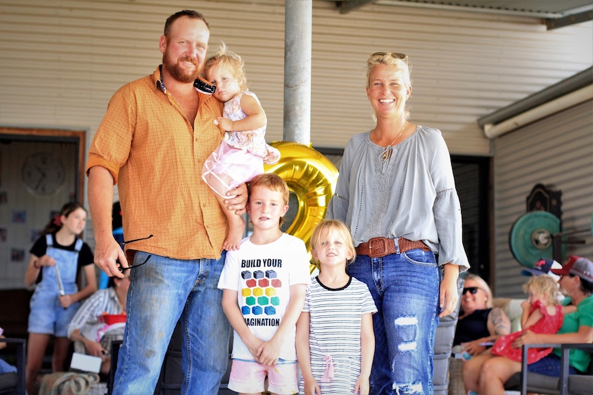 A family of five smile at a birthday party