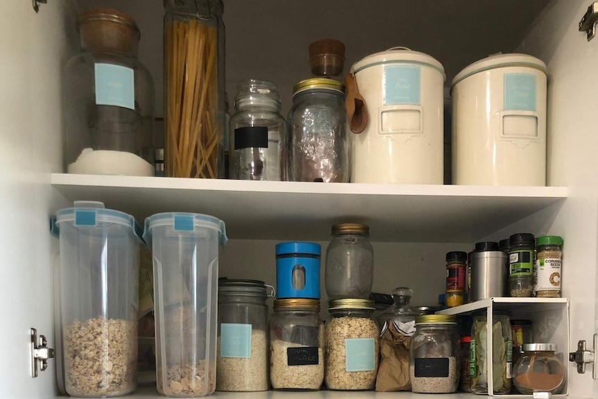 A stack of containers filled with food inside Chontelle Grecian's pantry.