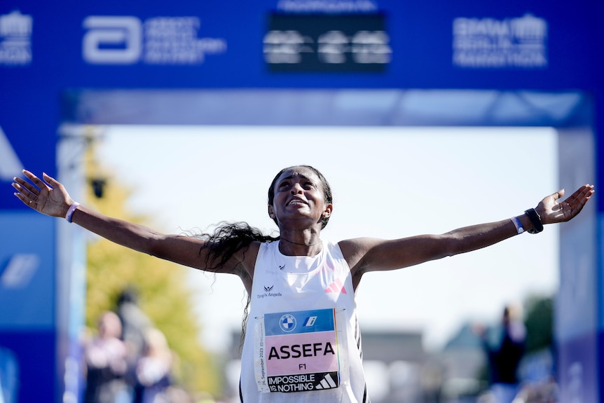 Ethiopia's Tigist Assefa celebrates with her arms outstretched