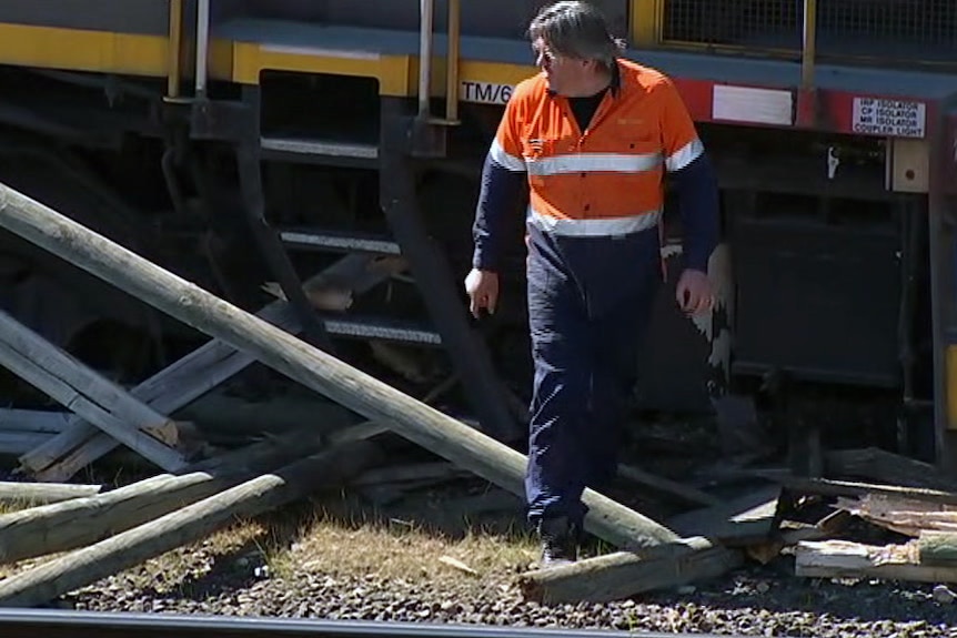 Worker walks past train crash
