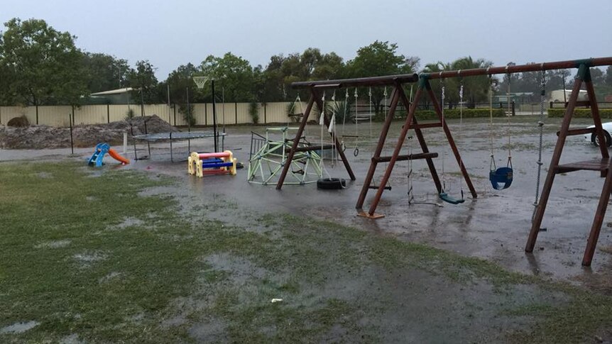 Rain falls on a playground in Emerald, Queensland.