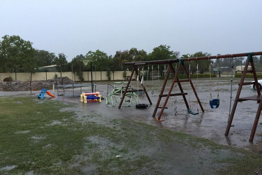 Rain falls on a playground in Emerald, Queensland.