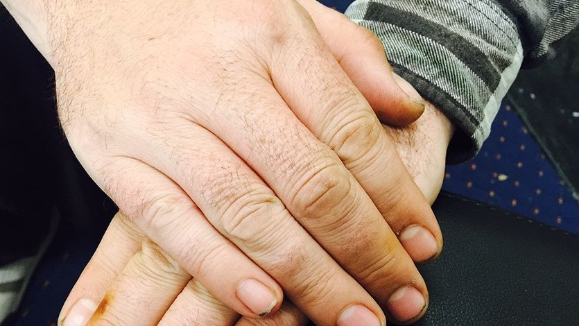 Close up of a man's hand folded across each other