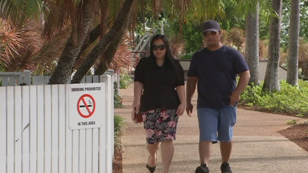 Two people walking into a courthouse.