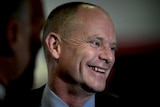 Campbell Newman smiles as he addresses the media
