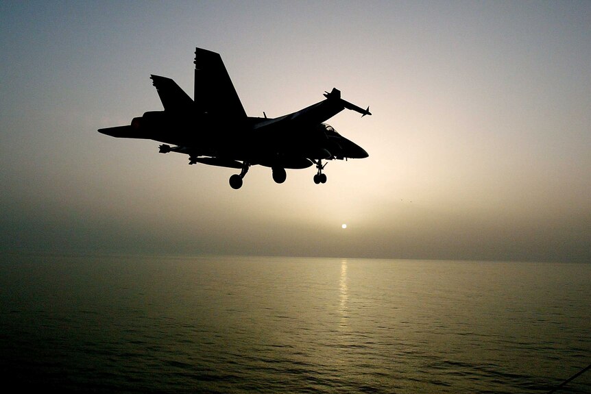 Silhouette of a war plane over the Persian Gulf.