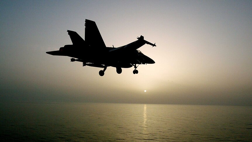 Silhouette of a war plane over the Persian Gulf.