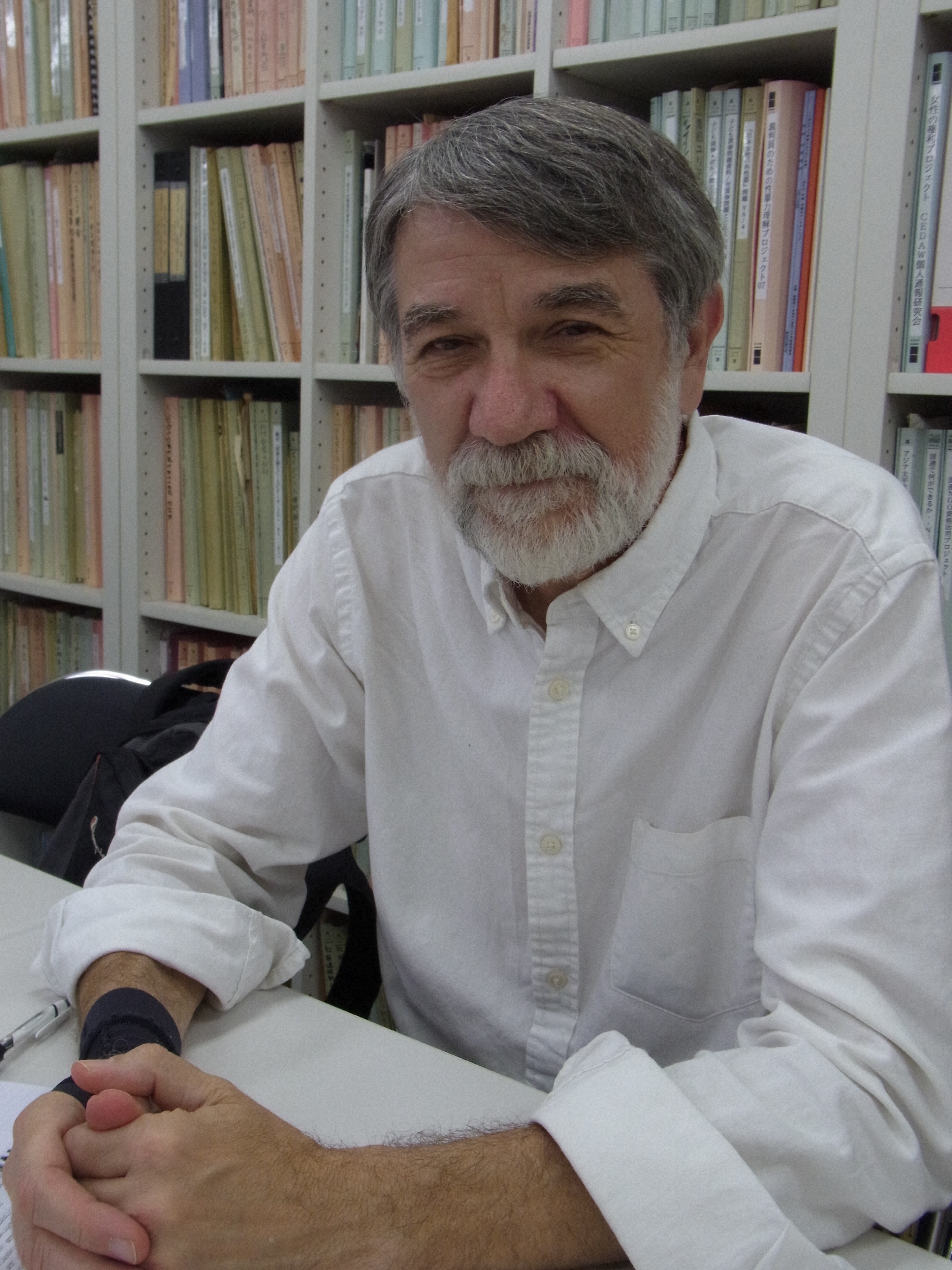 A headshot of Professor Repeta sitting in a library.