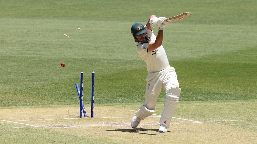 Mitch Marsh's stumps are broken as he completes a drive during a Test.