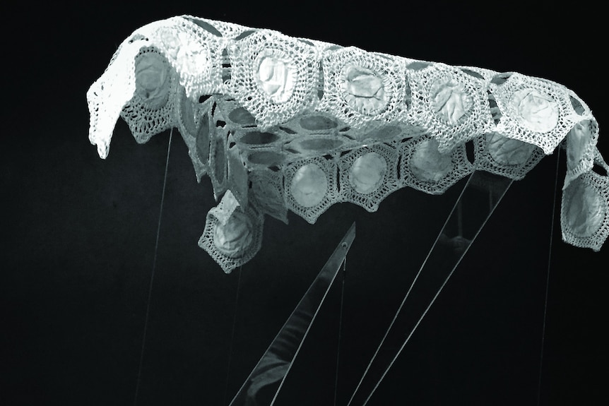 Embroided lace cloth in the style of a spider's web.