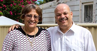 Reifat Botros and his wife Ezis Botros stand in their backyard.