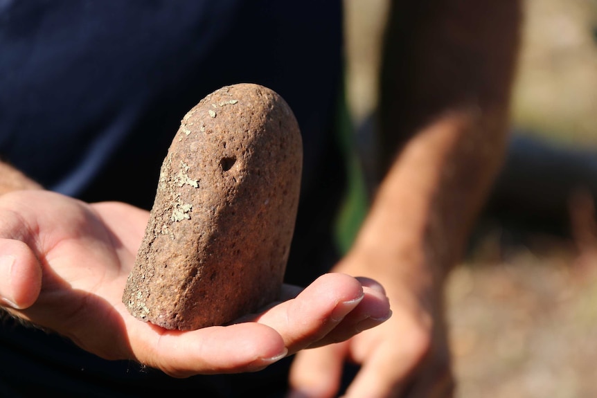 Tyronne Bell holds a rock hammer.