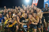 A group of NT Nightcliff Tigers players celebrate