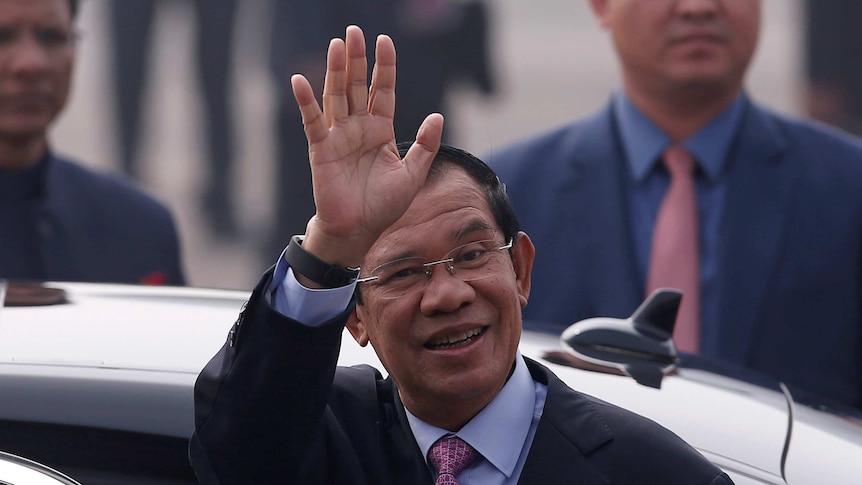 Cambodia's Prime Minister Hun Sen waves to a crowd