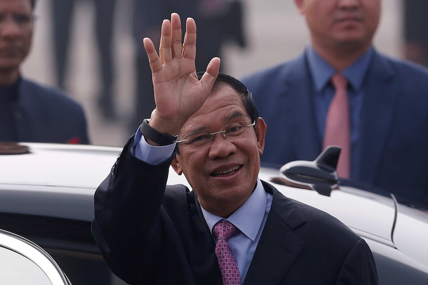 Cambodia's Prime Minister Hun Sen waves to a crowd