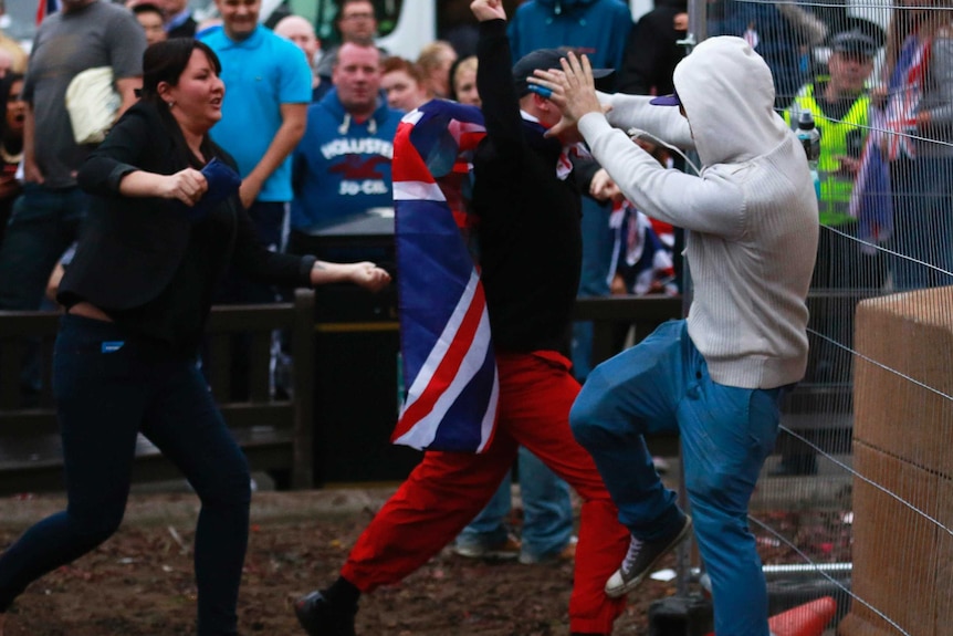 A pro-independence protestor (R) tussles with pro-union protestors during a demonstration at George Square in Glasgow, Scotland September 19, 2014.