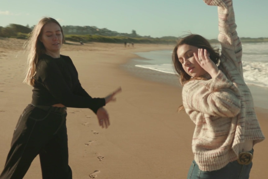 Vlada and Maria dance on a beach