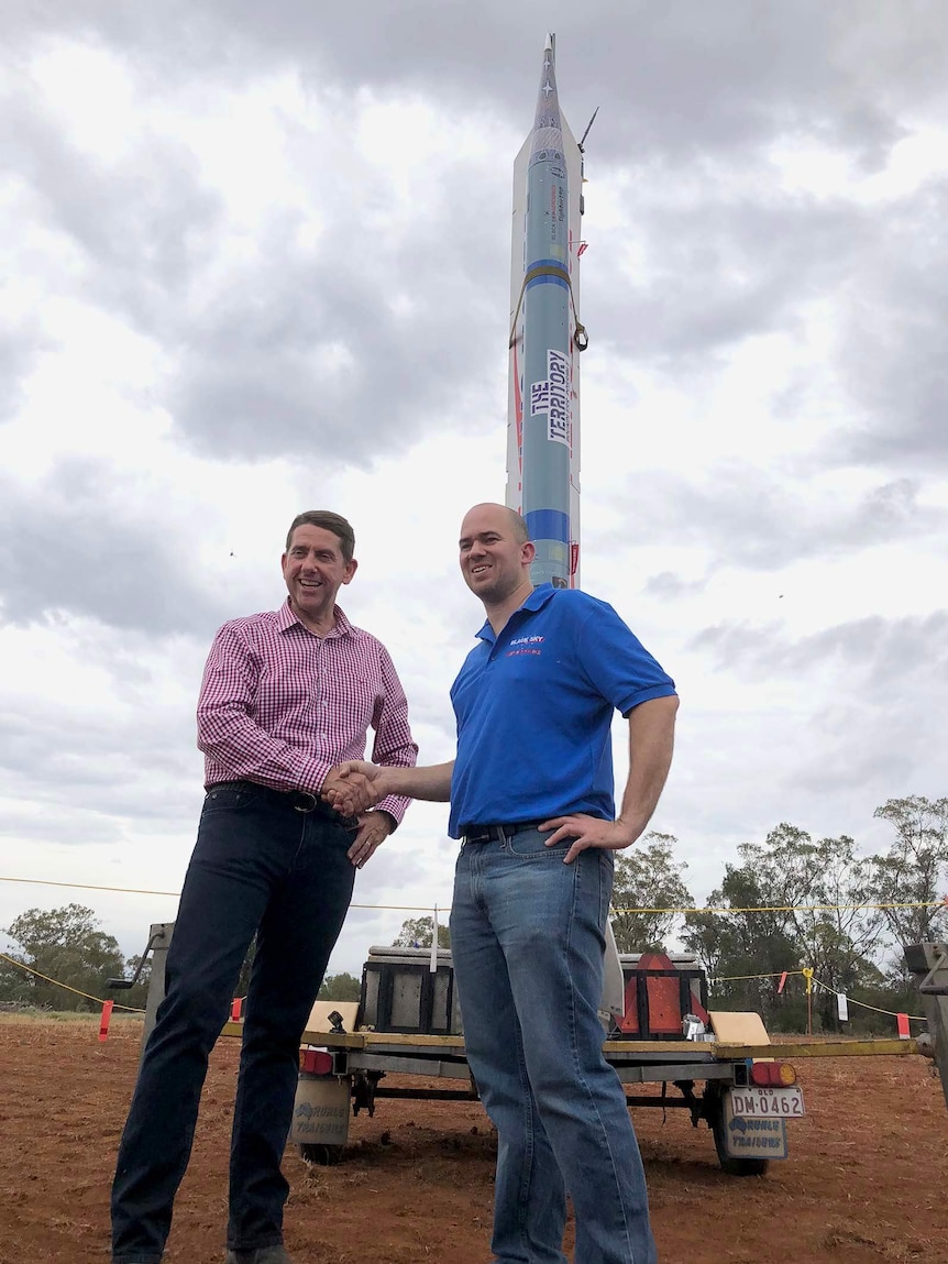 Cameron Dick and BlackSky's Blake Nikolic with the rocket