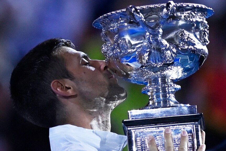 Novak Djokovic kisses trophy