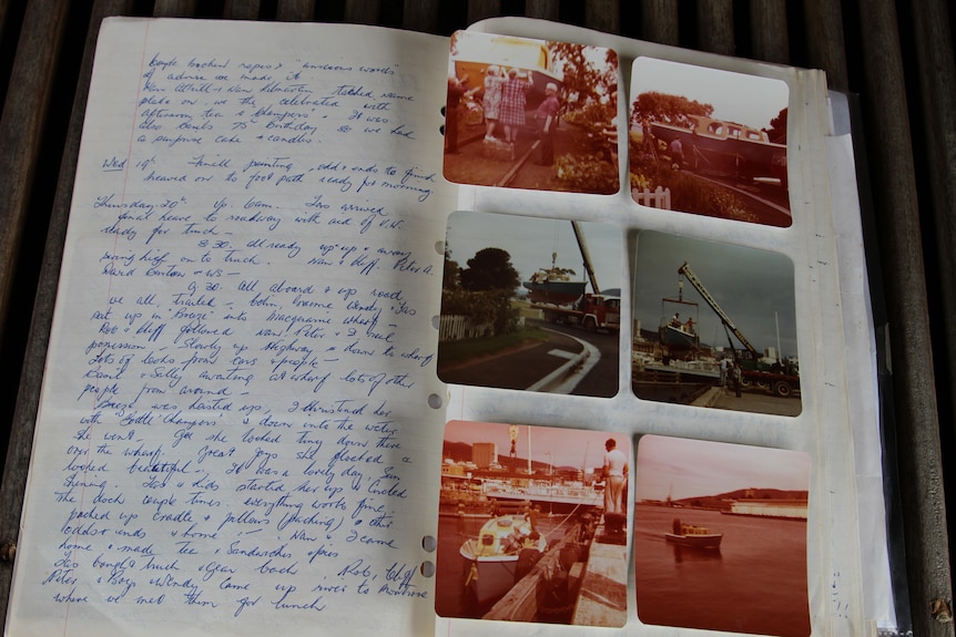 a picture of a scrap book with photos of a boat and cursive writing