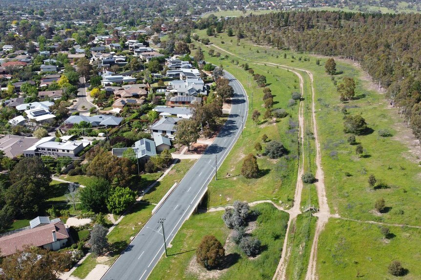 Drone shot showing grassed area near Canberra houses