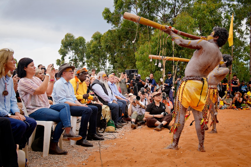 Anthony Albanese in front of Aboriginal performers playing the didgeridoo