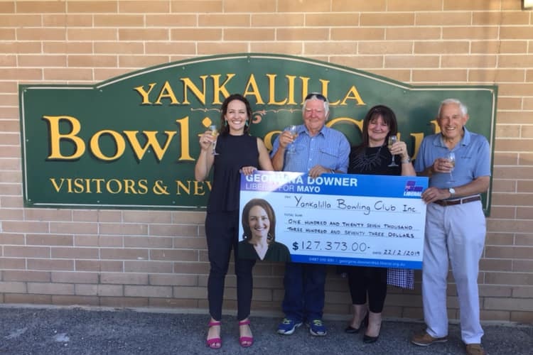 Liberal candidate for Mayo Georgina Downer hands over a novelty cheque to the Yankalilla Bowling Club.