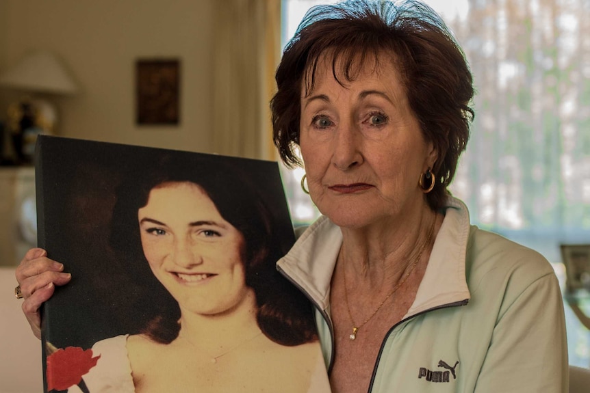 Colleen Holding with a picture of her missing daughter Kim Teer