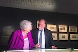 Holocaust survivor Irma Hanner and Warren Fineberg stand before a display at the AWM.