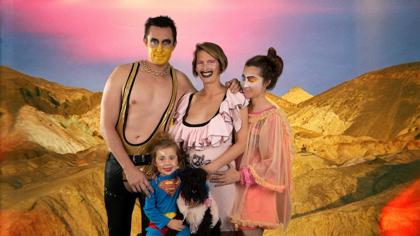 Family portrait of lesbian parents, their daughter, and sperm donor father.