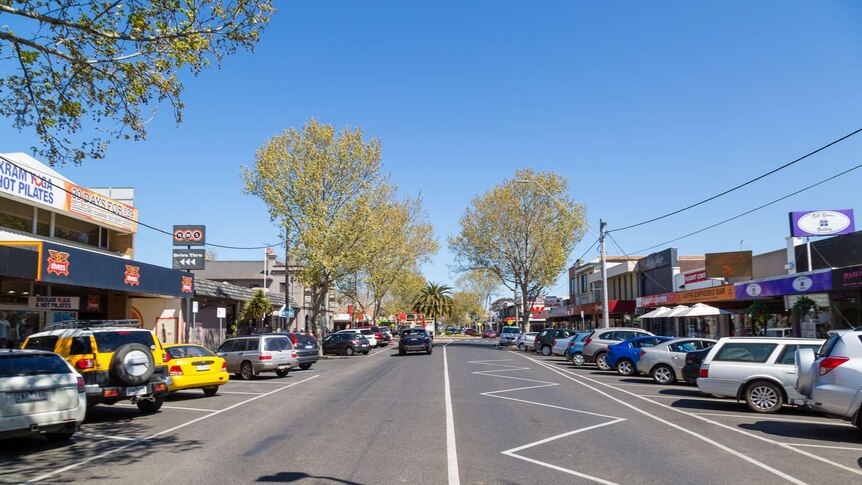 Shops and cars line the main street in the suburb of Werribee.