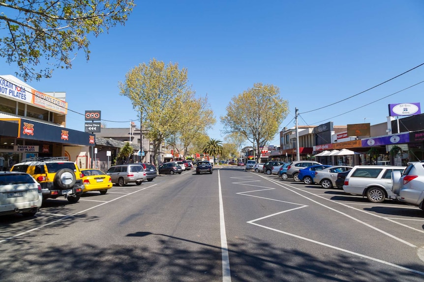 Shops and cars line the main street in the suburb of Werribee.