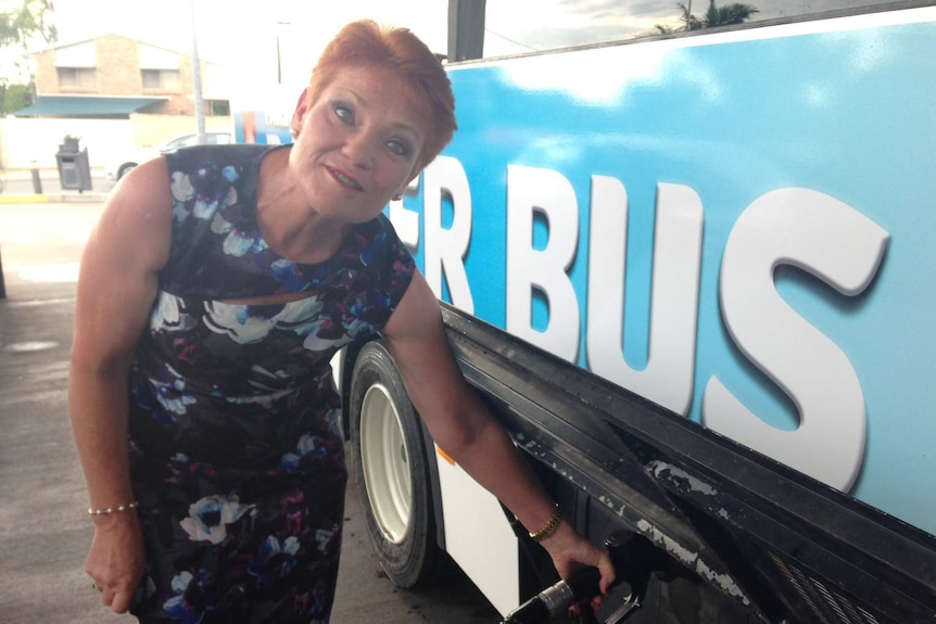 Pauline Hanson fills up her campaign 'battler bus' with fuel during the Queensland election campaign 2017.