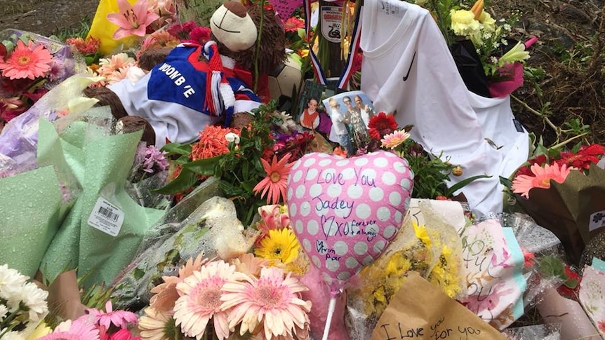 Flowers and memorabilia are left at the side of the road where a fatal crash took place on the sunshine coast.