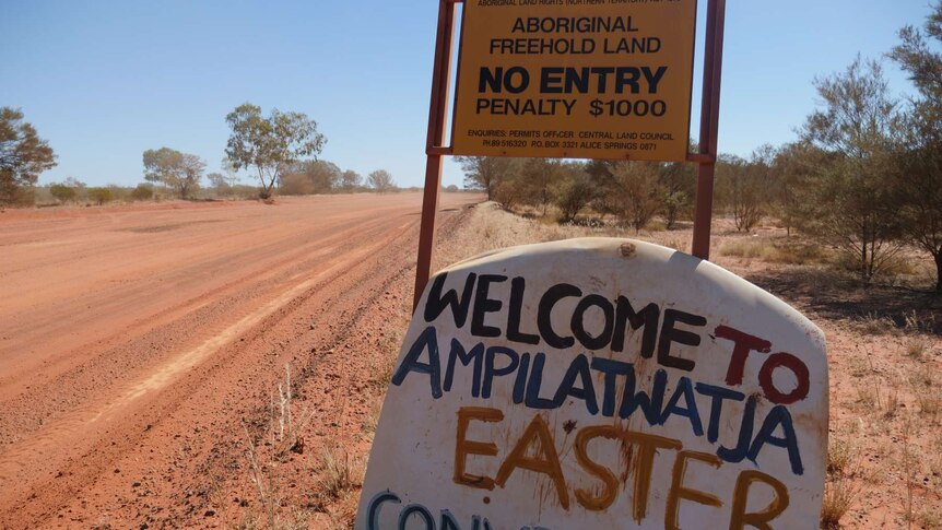Improvised road sign welcoming visitors to Ampilatwatja.