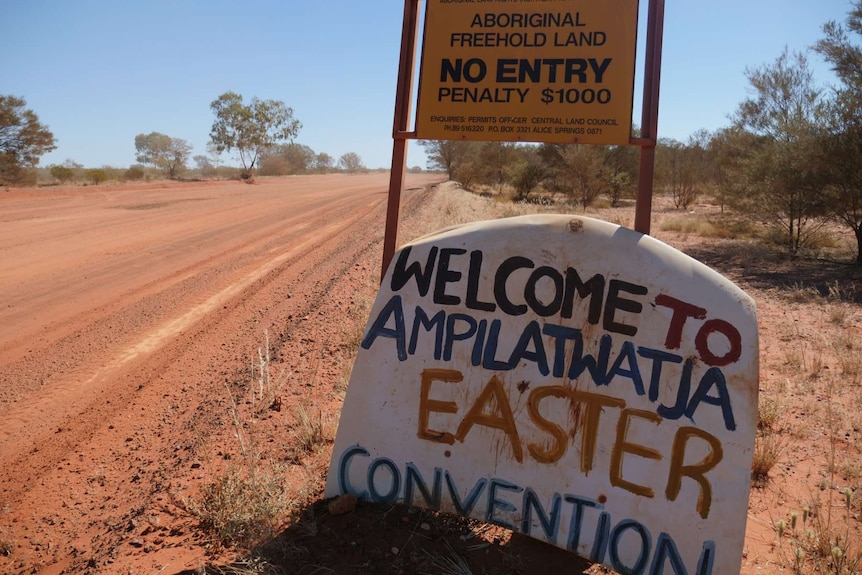 Improvised road sign welcoming visitors to Ampilatwatja.