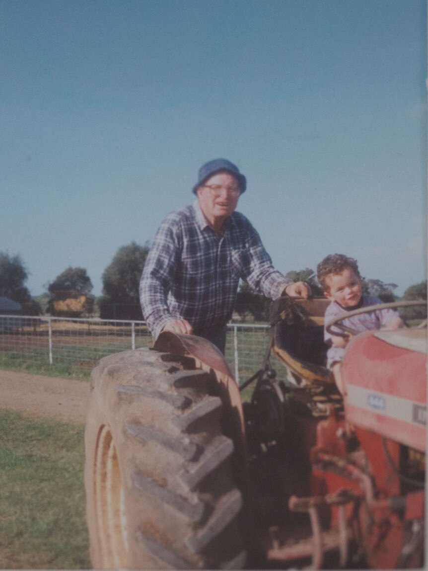 Don on a tractor with his grandson.