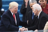 Donald Trump shakes Joe Biden's hand as Barack and Michelle Obama look on at the 2017 presidential inauguration.