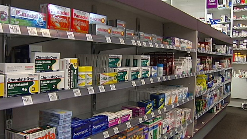 Drugs lined up on pharmacy shelves.
