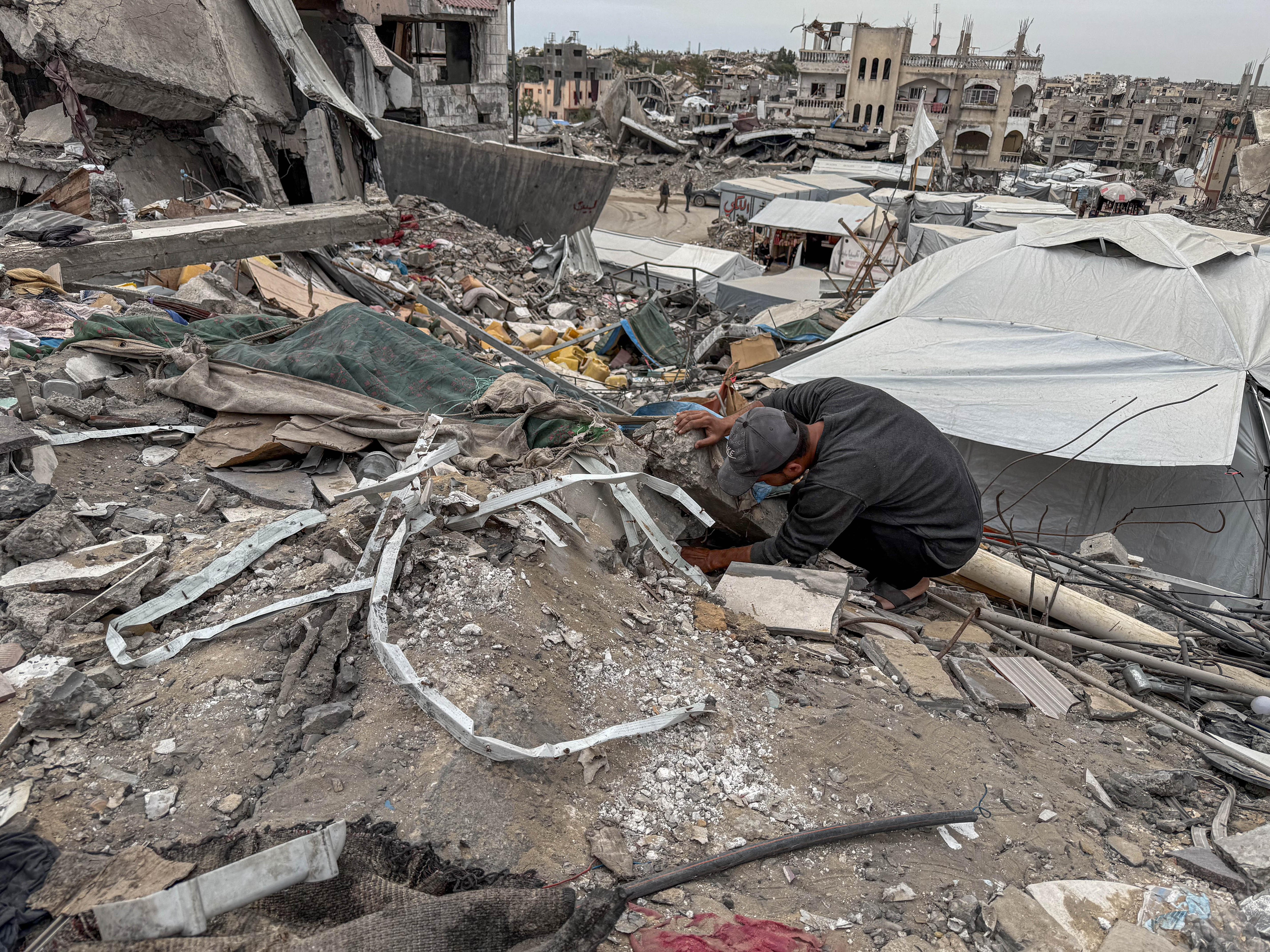 A man among the rubble of a destroyed home in Gaza.