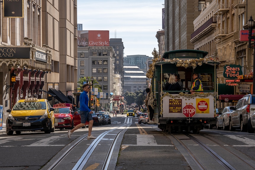 A street in San Francisco where trams, taxis and pedestrians share the road