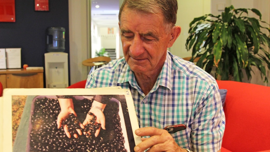 Man holding a picture of dung beetles