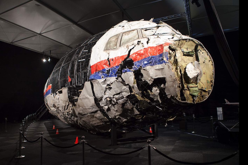 The nose of an airliner is reconstructed from damaged pieces.