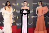 Three actresses standing on the red carpet in their gowns