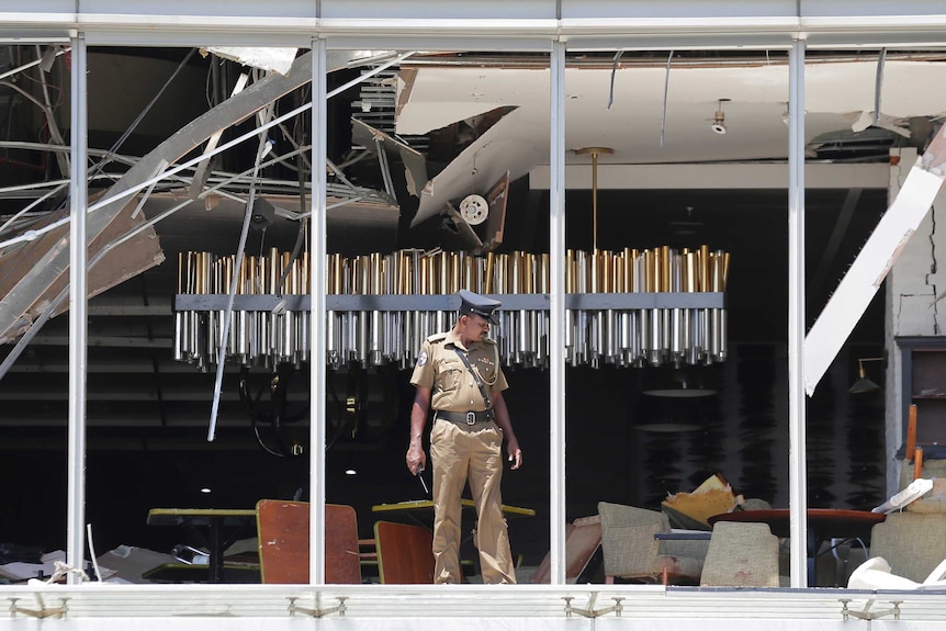 A Sri Lankan Police officer inspects a blast spot at the Shangri-la hotel in Colombo.