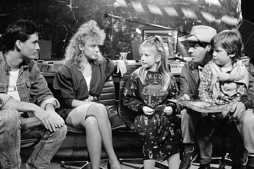 Molly Meldrum speaks with, among others, Kylie Minogue (2nd left), on the set of Countdown.